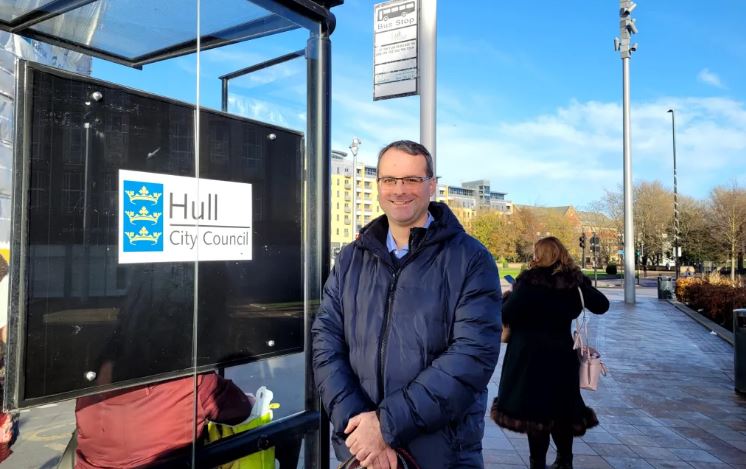 An image of Councillor Ileronimo at a bus stop